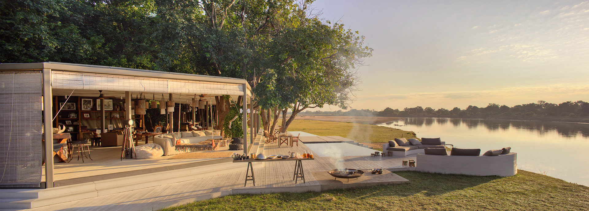 Comfort and class on an outdoor sofa beside the Luangwa River at Chinzombo