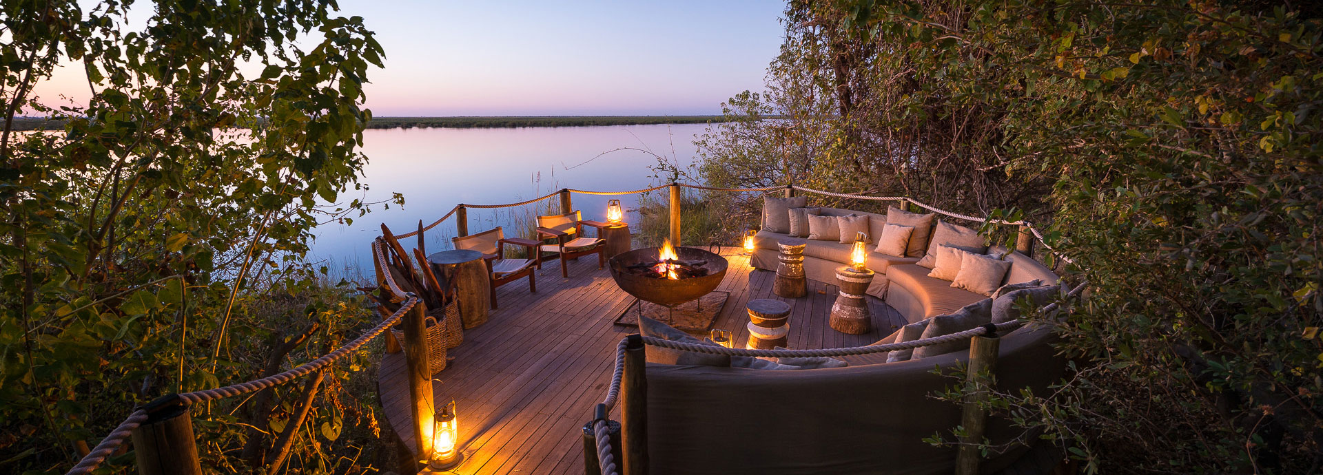 Exchange safari stories by the fire at sunset while overlooking the Osprey Lagoon at Duma Tau