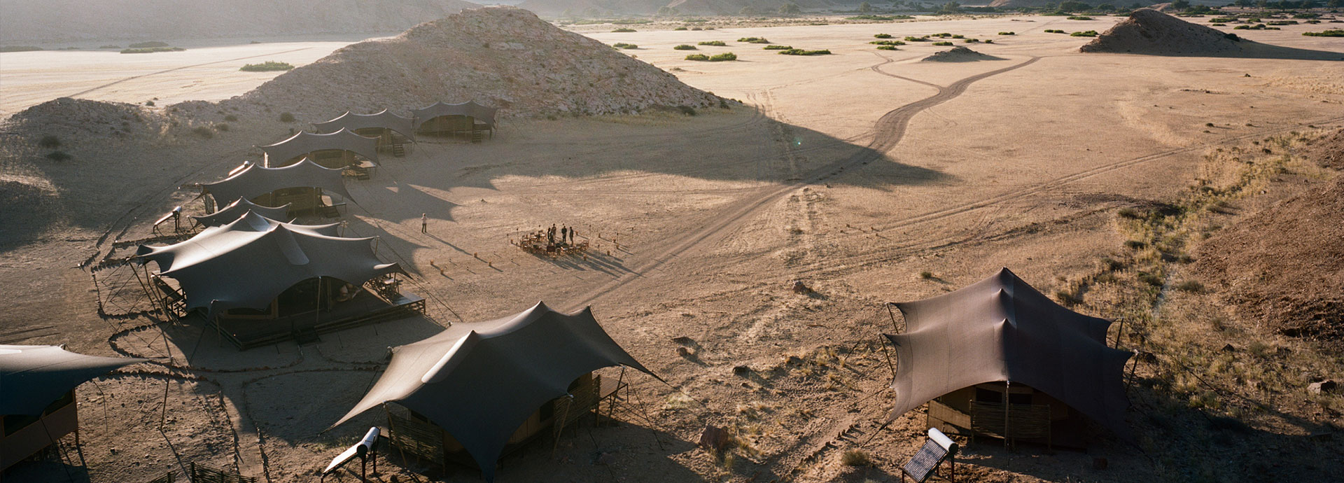 Sand dunes surround Hoanib Valley Camp in Namibia