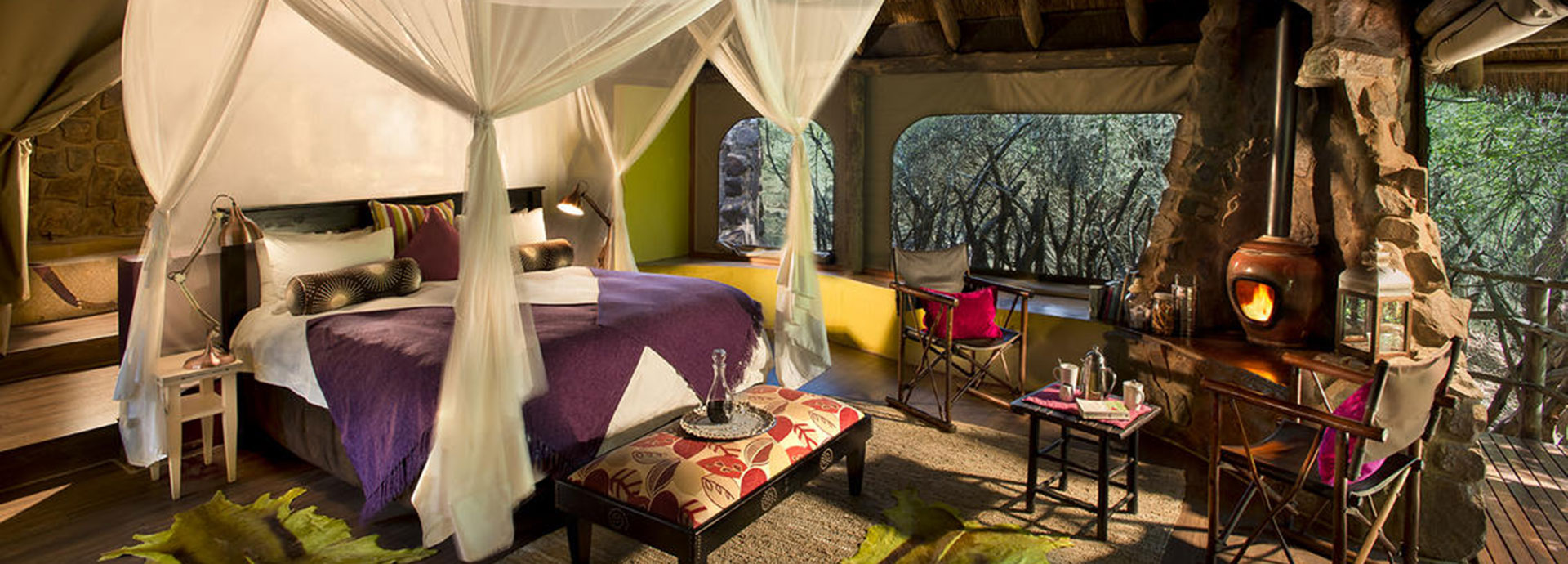 Bright colours and a fireplace inside your room at Jaci's Safari Lodge
