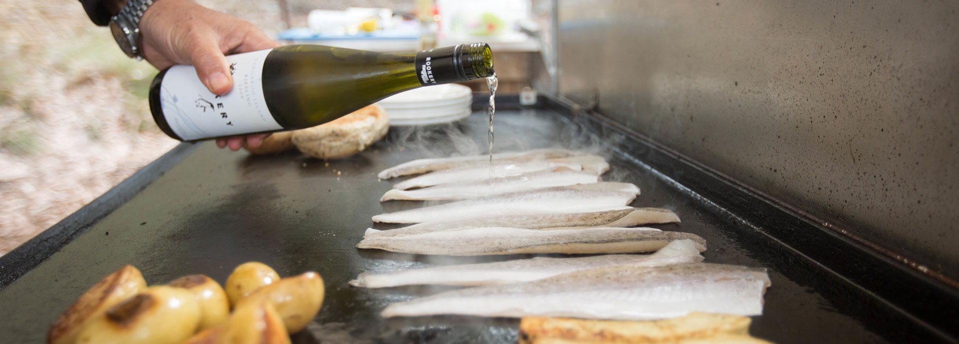 Freshly caught fish being barbequed and coated in local wine