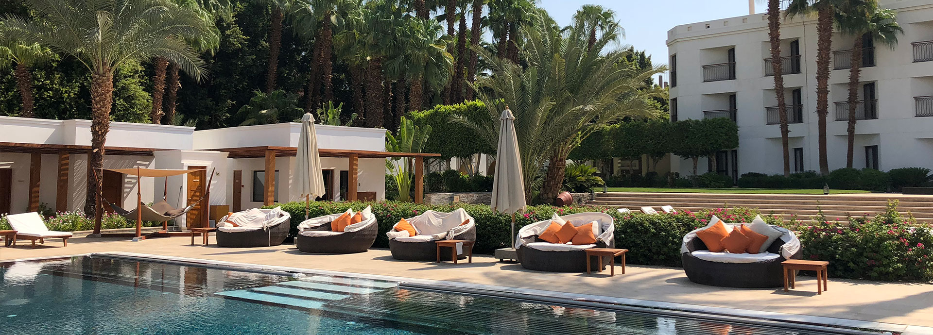 Palm trees, pool and refreshment overlooking the Nile at the Hilton Luxor Resort & Spa