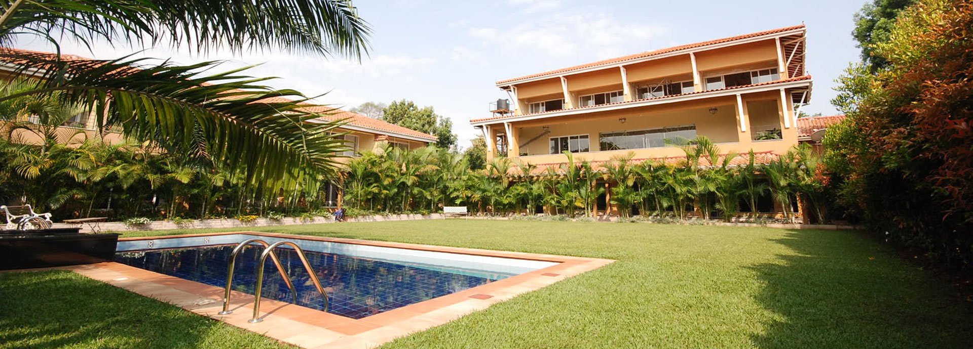 Cool down by the pool surrounded by lush gardens at No. 5 Boutique Hotel in Entebbe
