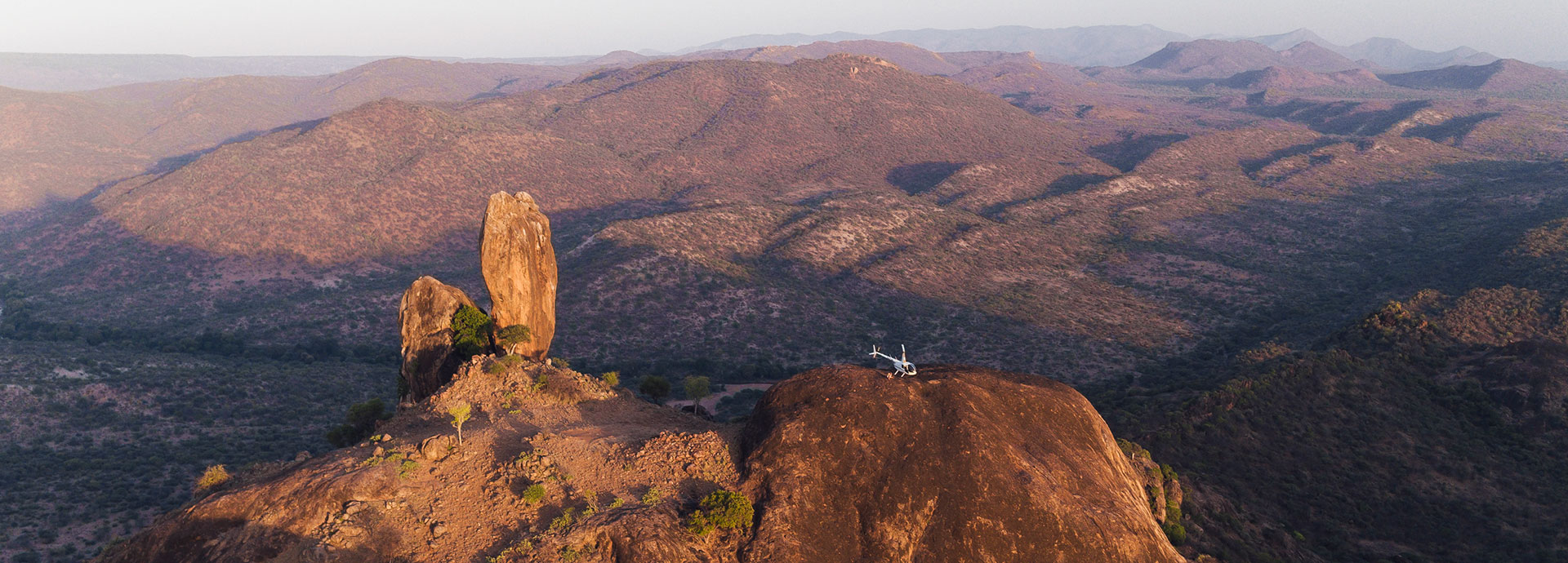 Helicopter sitting on a ridge in Kenya's Mathews Ranges
