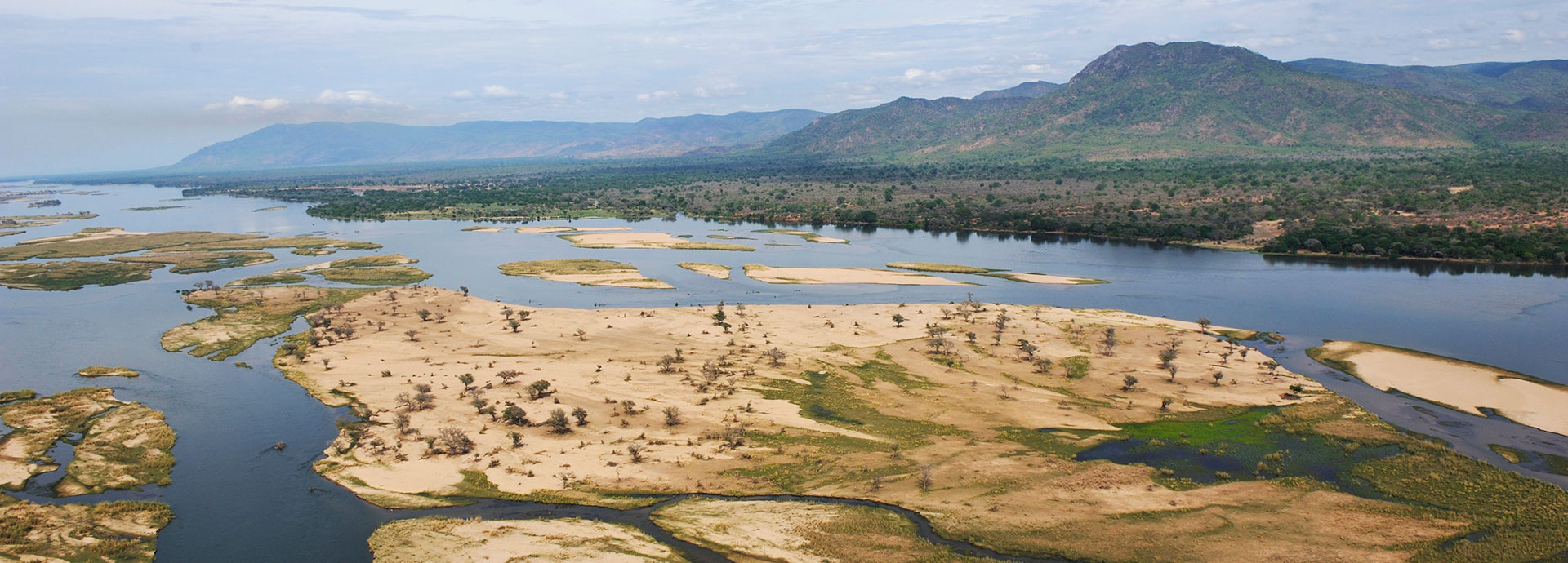 Nestled in over an expanse of open land and the waters of the Zambezi, sits Potato Bush Camp