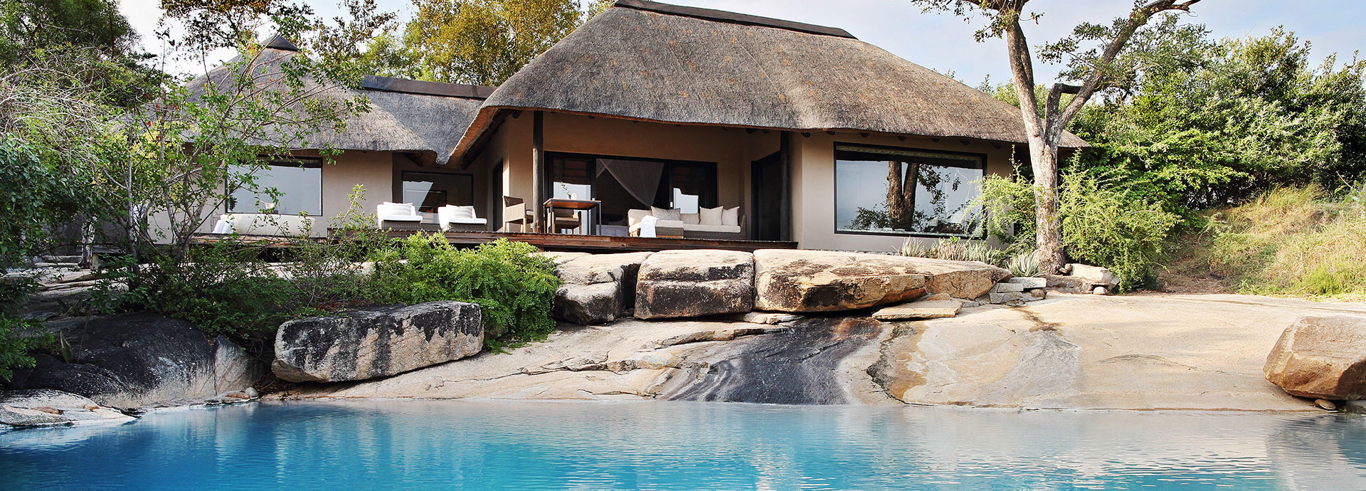 Cool down in the heat of the day in the pool or on the sun loungers at Londolozi Private Granite Suite