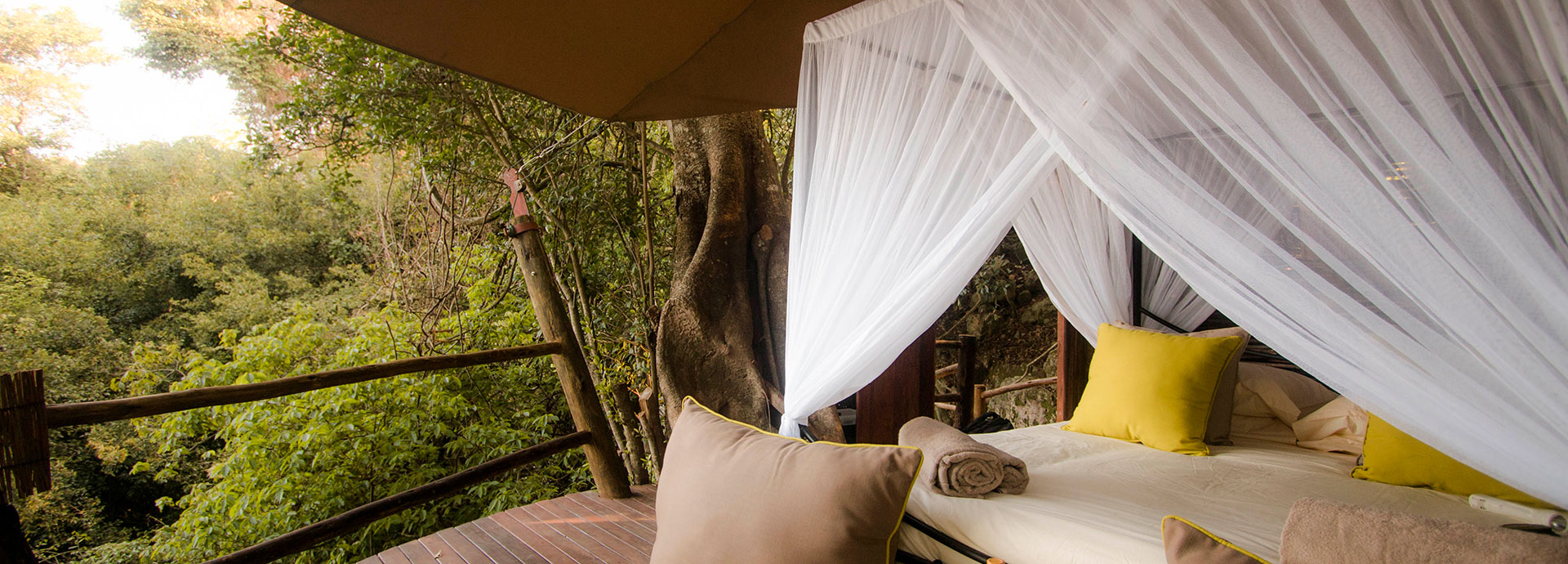 Peer out through the trees to see the colours of Lake Victoria, right from your bed at Rubondo Island