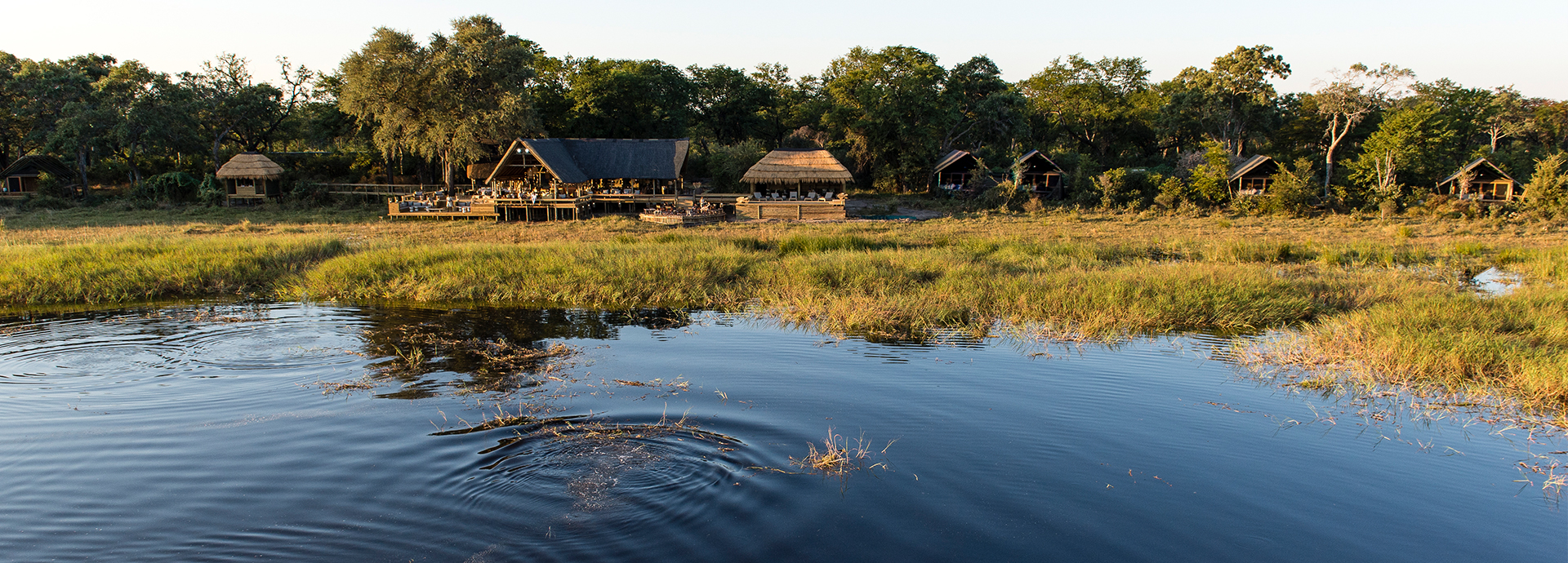 A wildlife rich lagoon sits in front of Sable Alley in Botswana