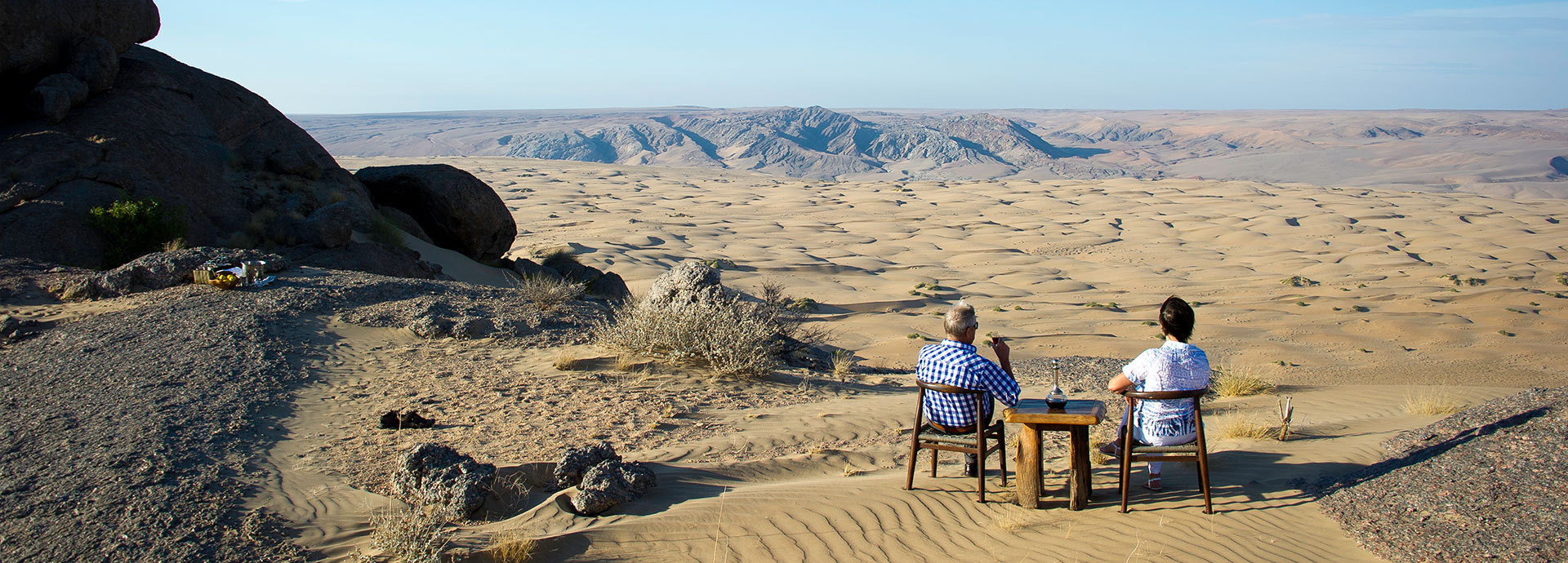 Guests view the otherworldly landscapes of Kaokoveld, Namibia from Serra Cafema Camp