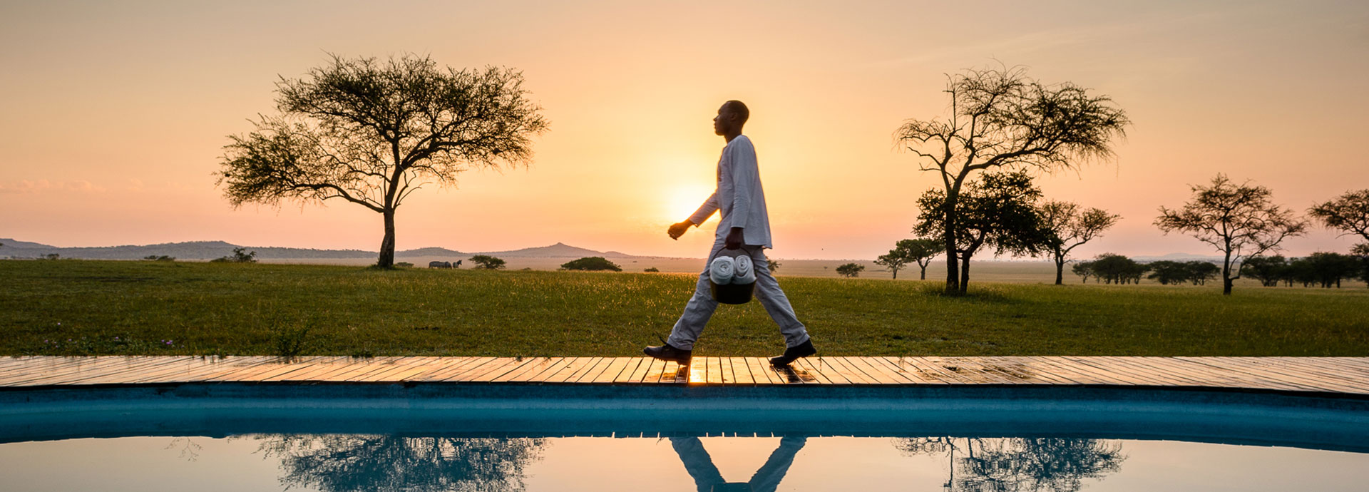 Peer out into the Grumeti Reserve while relaxing in the pool at Singita Sabora