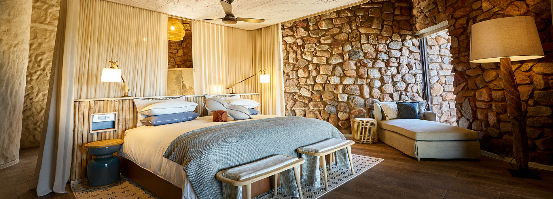 Tswalu Motse is a secluded camp of nine dwellings, each with an open viewing deck and open fireplace overlooking the Kalahari landscape.