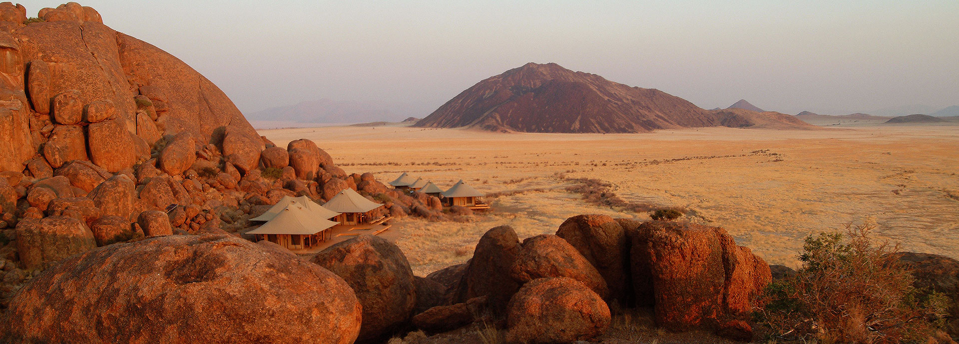 Luxury tents blend in seamlessly with massive granite rocks at Wolwedans Boulders Camp