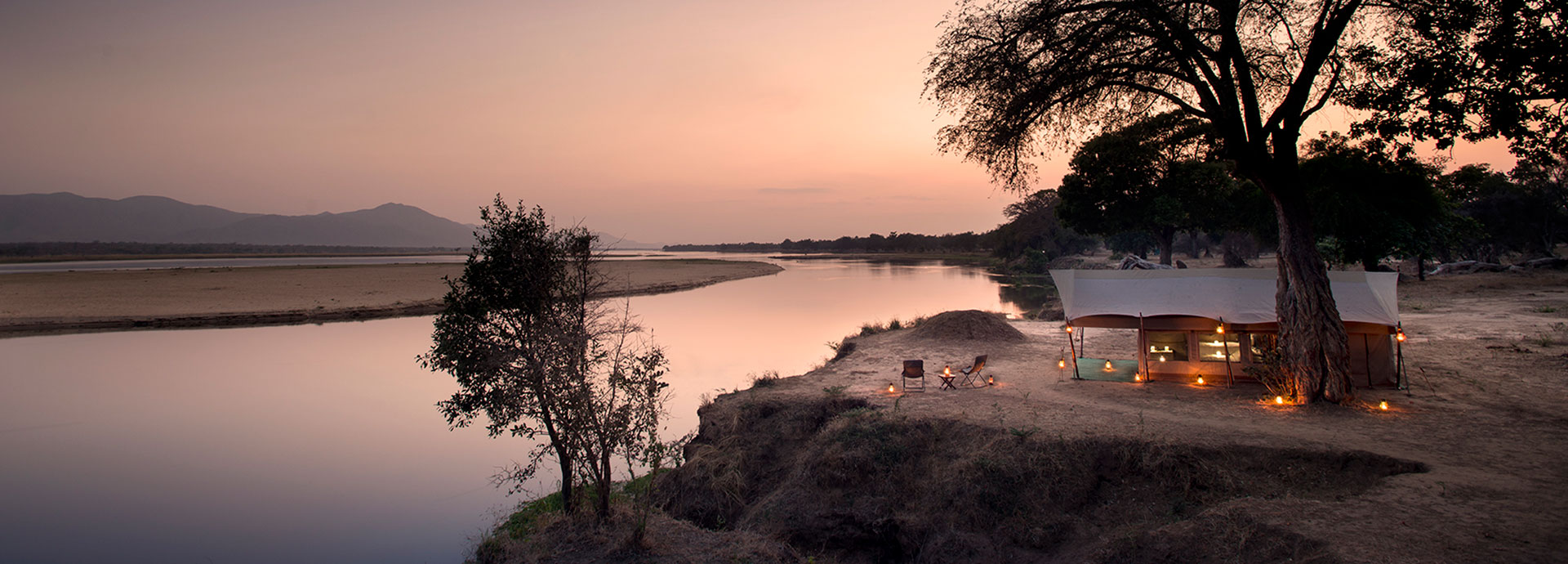Elegant under canvas tented accommodation by the river's edge at Zambezi Expeditions