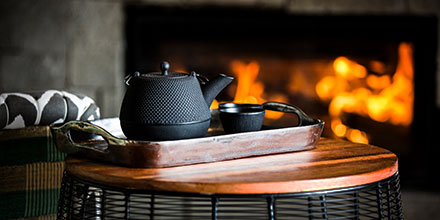 Tea set in front of an open fire at a luxury lodge in Rwanda