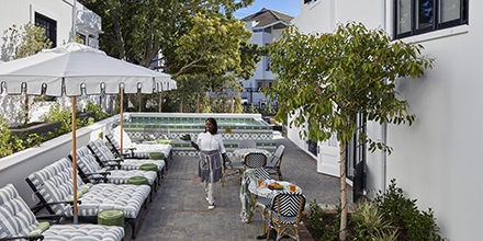 Tranquil garden and pool area with seating at Cape Cadogan Boutique Hotel