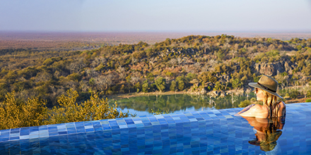 Woman in stunning infinity pool at Singita Malilangwe House, Zimbabwe