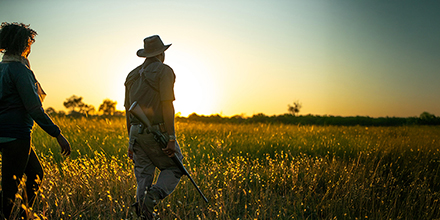 Guests and safari guide on a sunset walking safari in Botswana