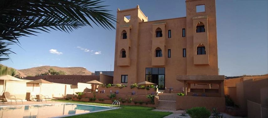 Exterior of Dar Chamaa with kasbah-style architecture overlooking the swimming pool.