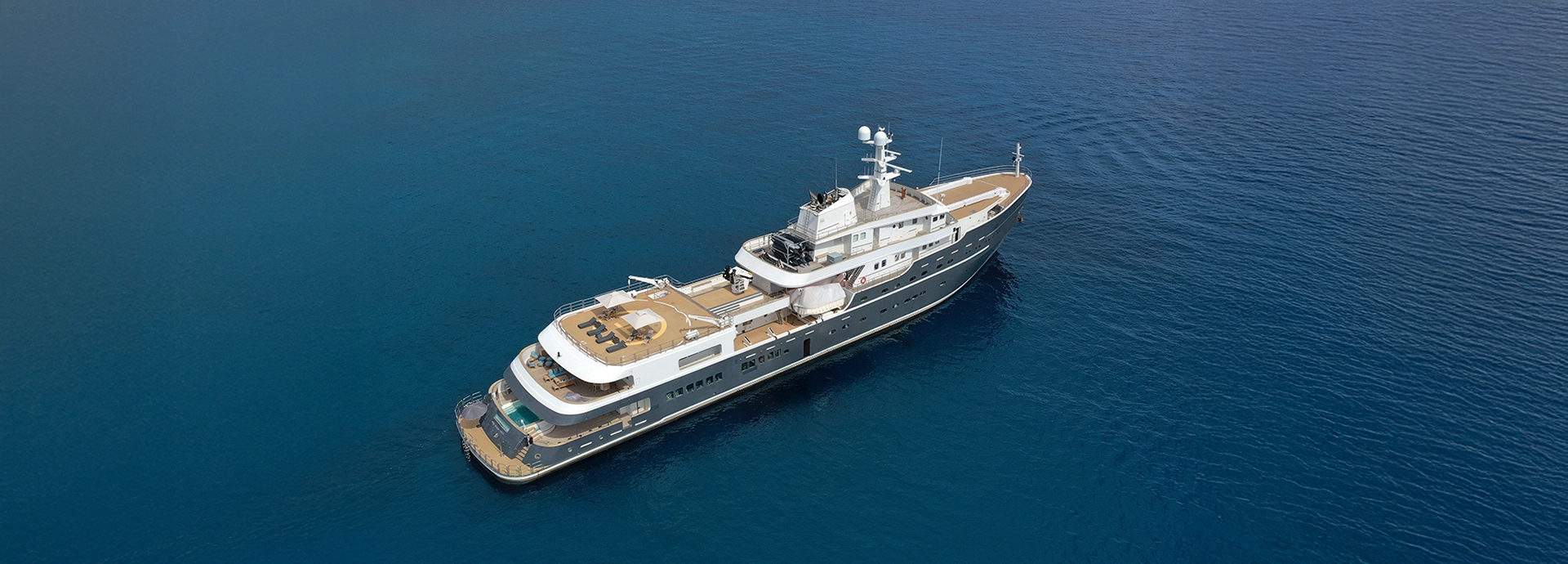 Aqua Lares cruising through tranquil tropical waters with elegant symmetry.