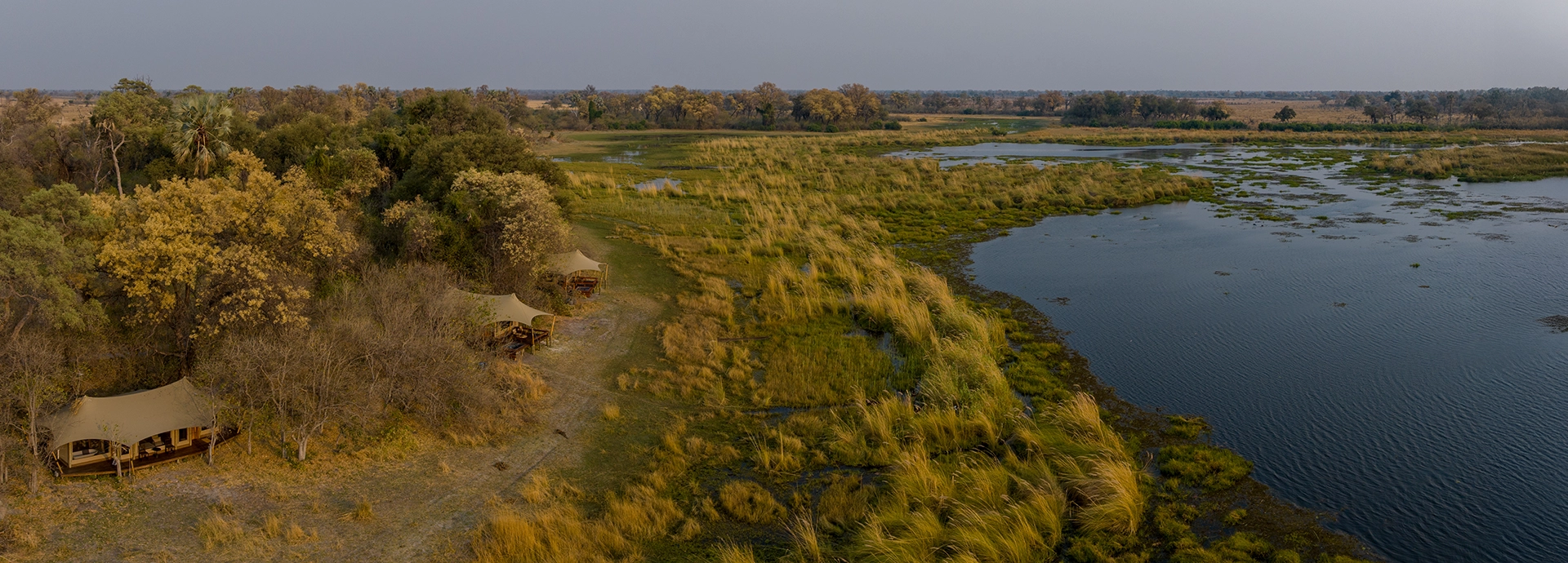 Aerial view of Cha Cha Metsi’s luxury tents along the lagoon in the Okavango Delta.