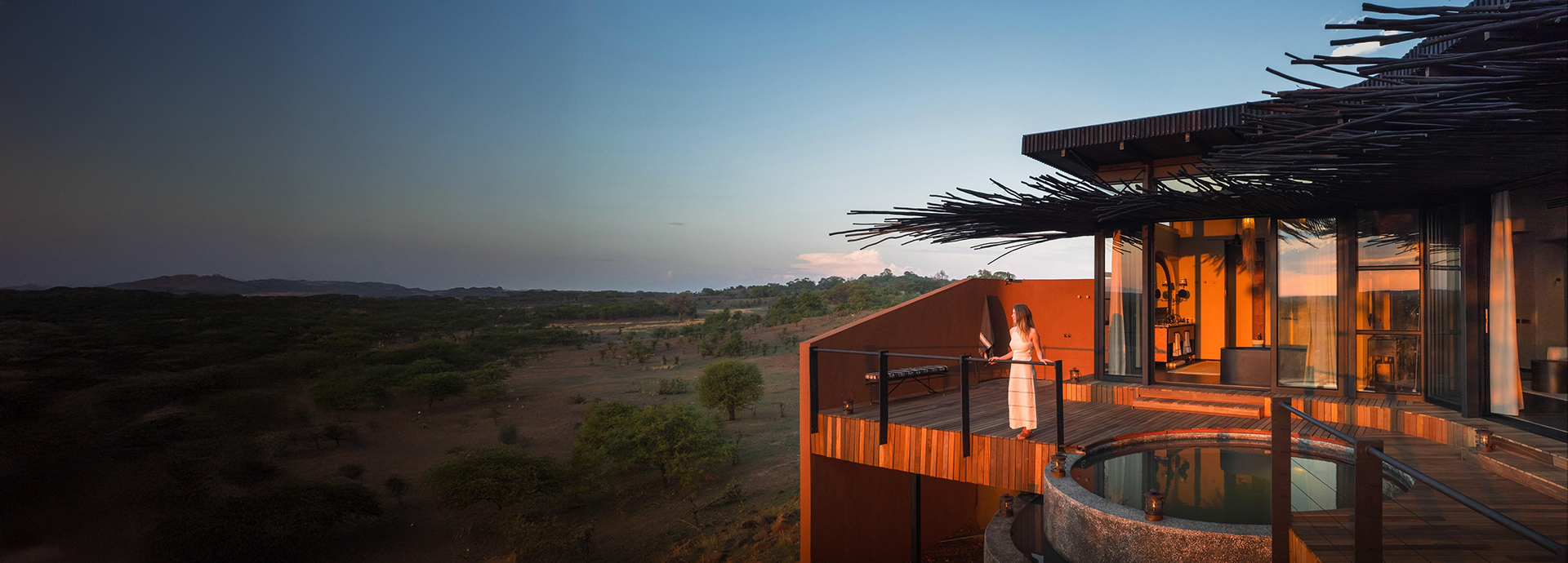 Guest watching thew sunset at Chichele Presidential luxury safari Lodge in South Luangwa National Park, Zambia