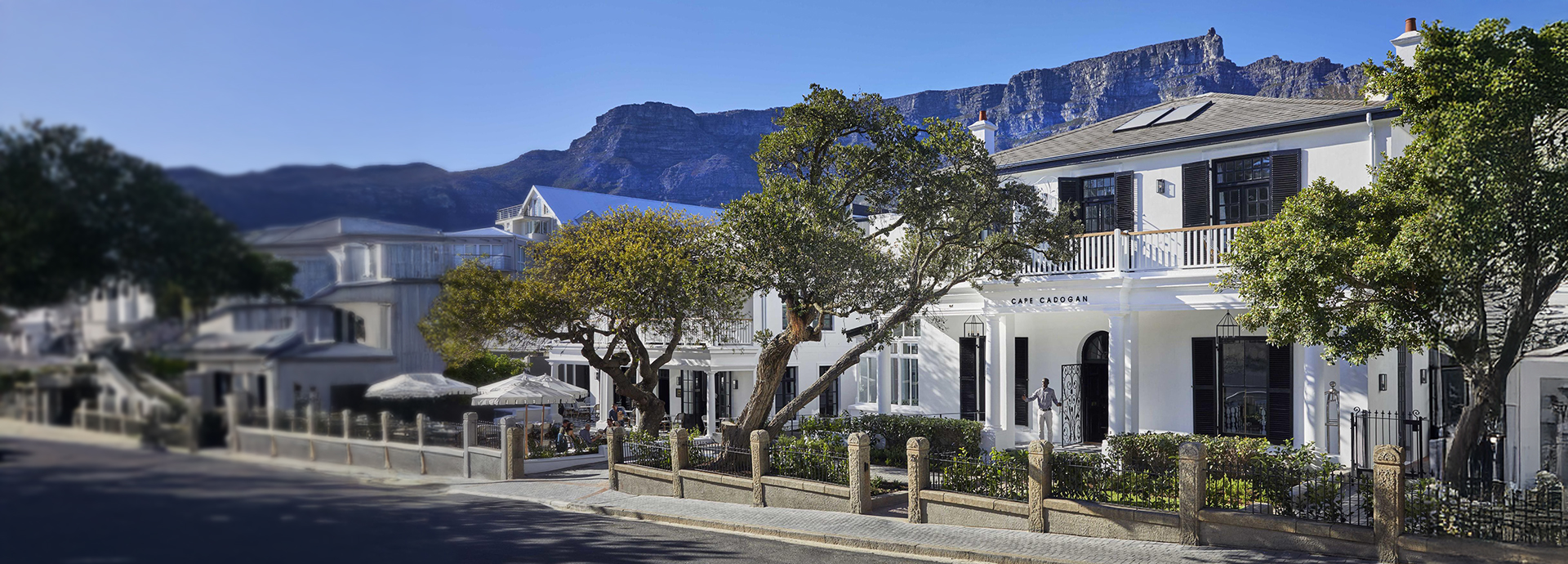 Street view of Cape Cadogan boutique hotel with a spectacular mountainscape in the background