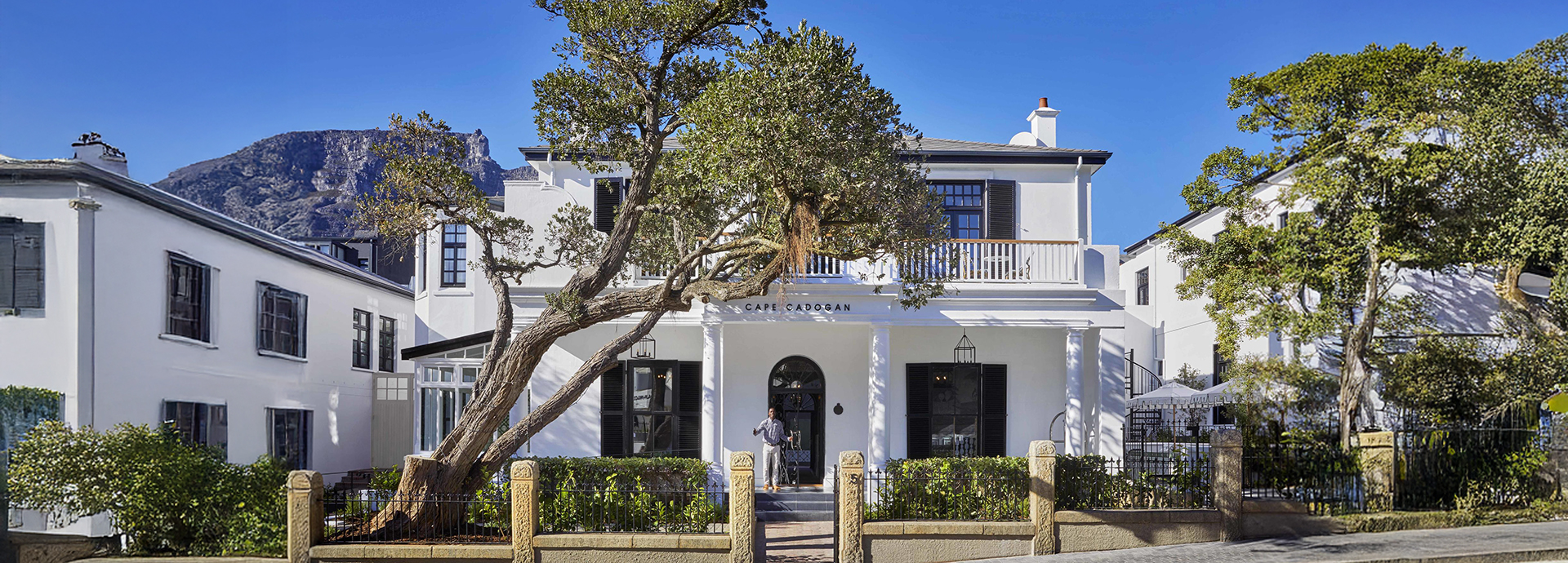 Front view of Cape Cadogan Boutique Hotel with mountain backdrop