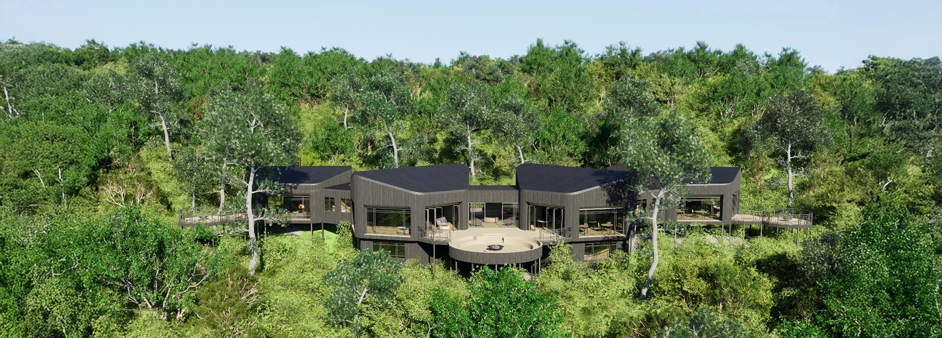 Aerial view of Lemala Osonjoi Lodge showcasing sleek dark-wood design and integration with surrounding forest.