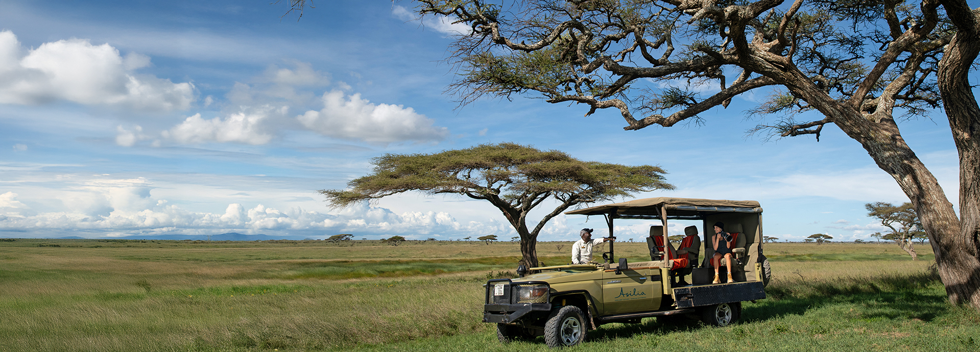 Guests enjoying a game drive at Namiri Plains Retreats near the Masai Mara, Kenya
