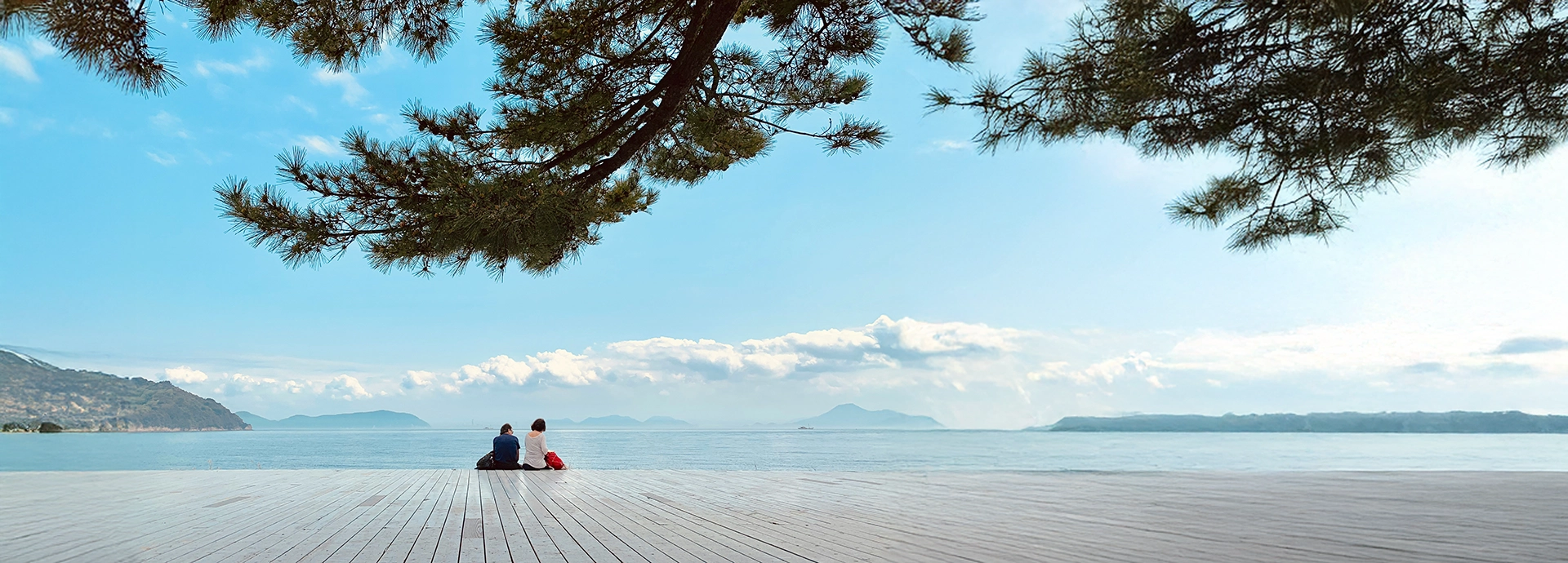 A quiet coastal platform on Naoshima Island overlooking the Seto Inland Sea, blending contemporary design with natural calm.