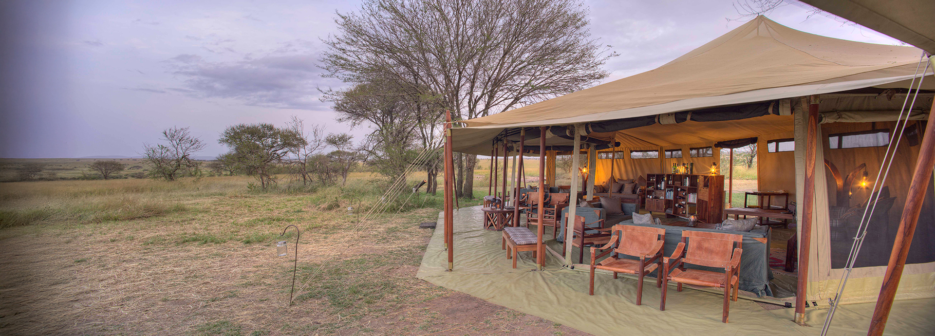 Open-sided lounge and dining area at Olakira Migration Camp overlooking the bush.