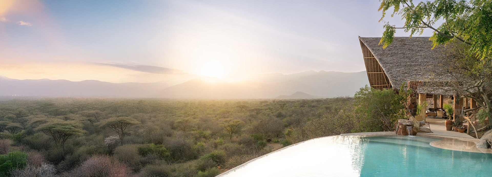 Infinity pool at Reteti House overlooking a vast acacia-dotted valley at sunrise.