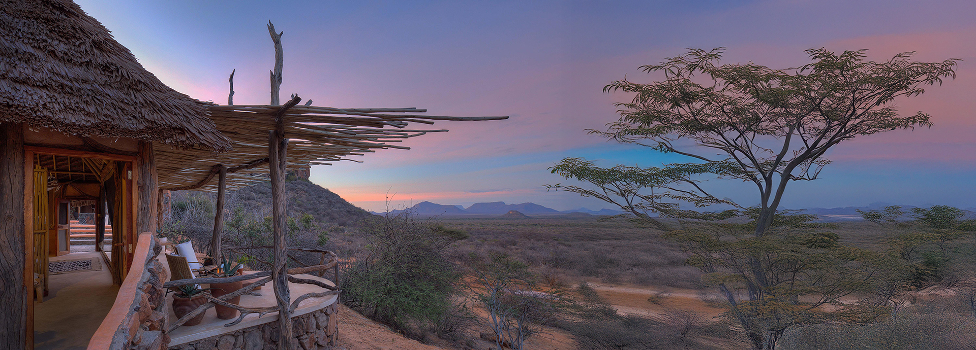 Sunrise casting pastel hues over the Samburu landscape, viewed from a Reteti House veranda.