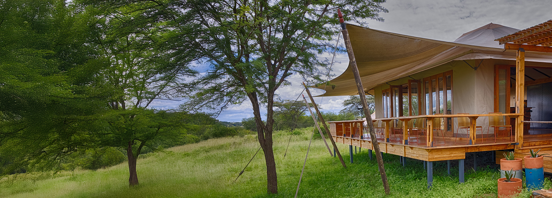 Timber deck extending from Sayari Camp’s bar area into the Serengeti wilderness