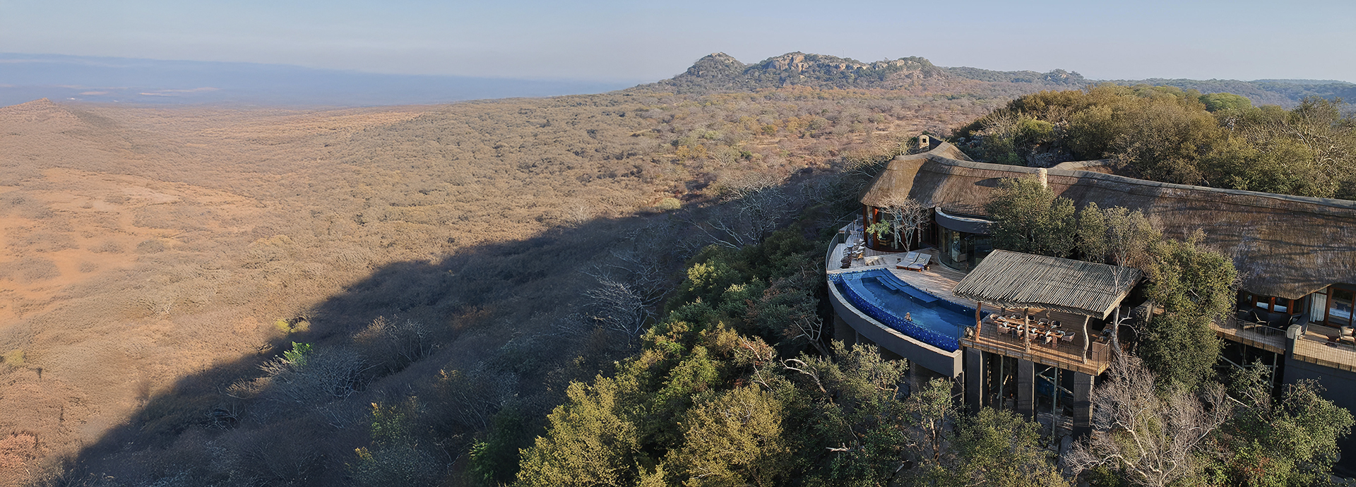 Aerial view of Malilangwe House on an escarpment overlooking a panoramic landscape