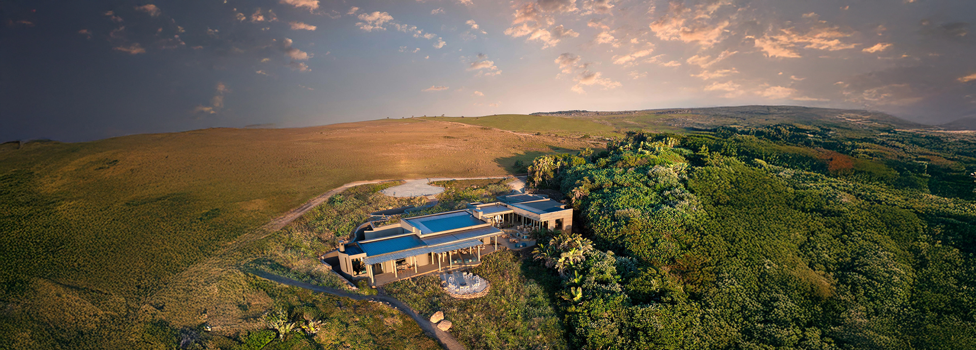 Expansive aerial shot of Gwegwe Beach Lodge framed by coastal forest and grasslands.