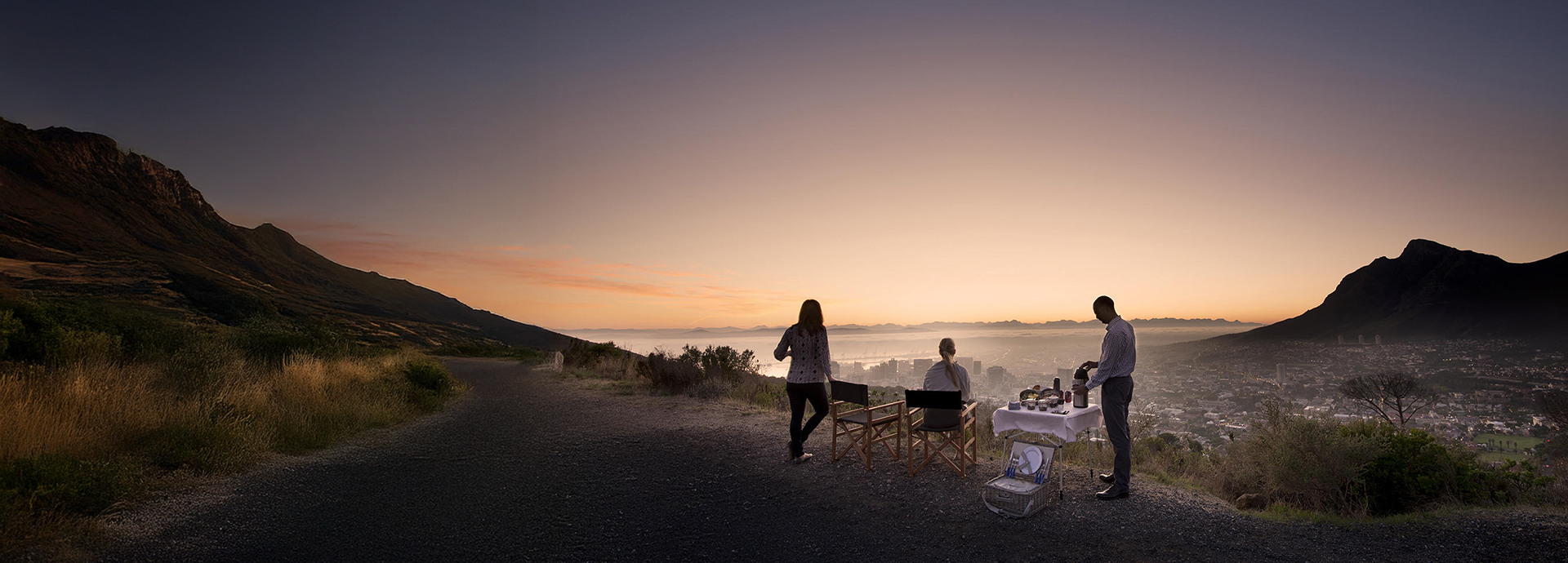 Sunrise breakfast setup overlooking Cape Town and surrounding mountains