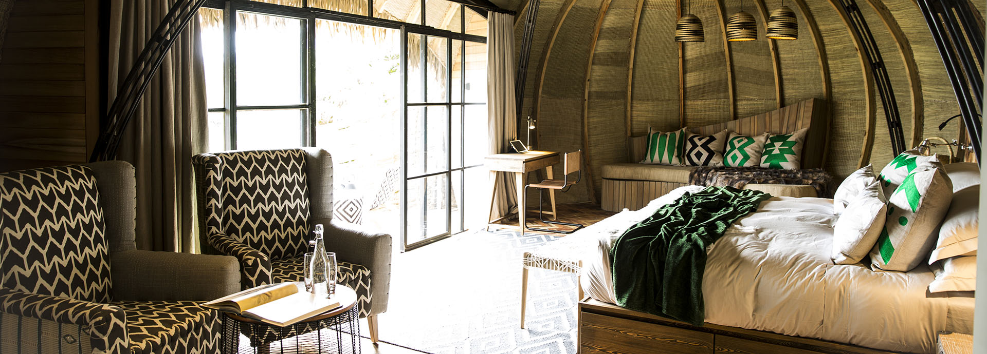 Luxurious double suite with a thatched roof in Rwanda's Volcanoes National Park