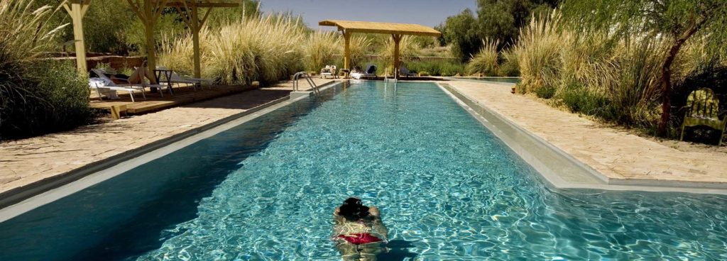 A guest swims in the glorious pool at Chile Explora in the Atacama Desert