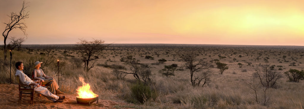 Enjoy unobstructed views of the vast Kalahari plains by the campfire as the sun sets at Tswalu