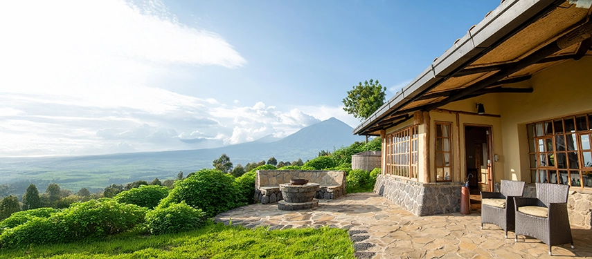 The terrace at Virunga Lodge looks out across rolling green hills towards the Virunga volcanoes, creating a peaceful setting for relaxed afternoons in Rwanda’s highlands.