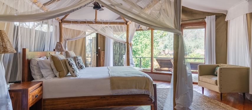 A luxurious en suite tent at Dulini Anabezi with a king-sized bed, soft netting, and a private deck.