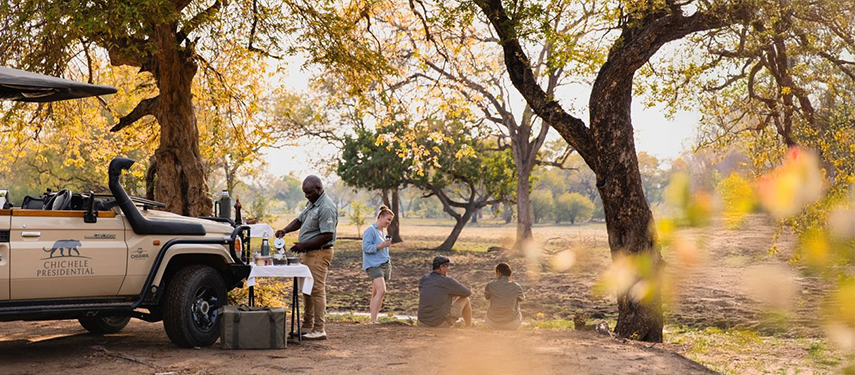 Guests enjoying sundowners on a luxury safari in South Luangwa National Park, Zambia