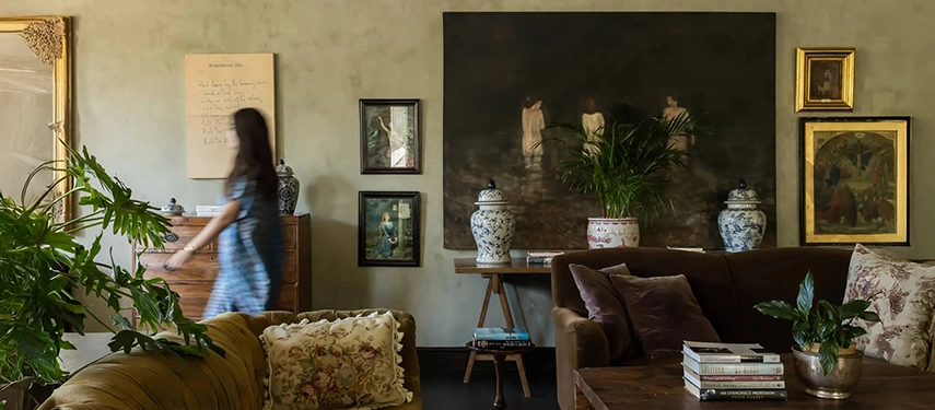 Eclectic lounge at Dorp Hotel featuring plush sofas, botanical decor, and moody artwork that reflects its creative spirit.