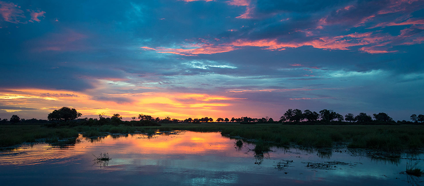 Sunset over water in Linyanti Wildlife Reserve