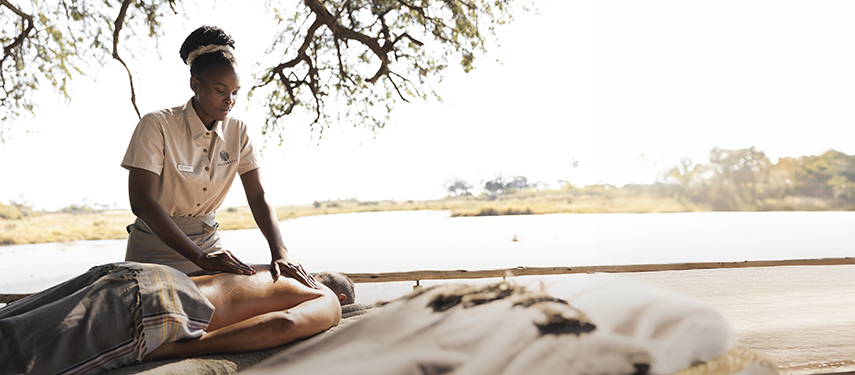 Waterside massage at King's Pool luxury safari Camp