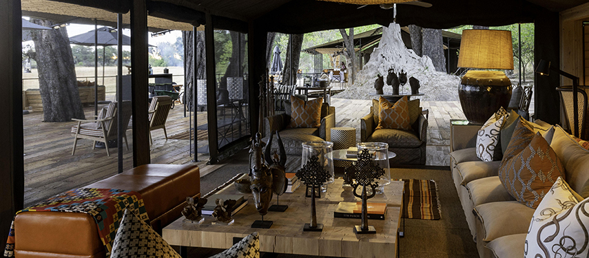 Cosy lounge area at Kiri Camp decorated with African-inspired furniture and textiles.