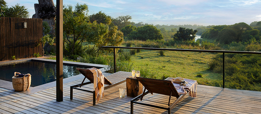 Private deck with sun loungers and plunge pool overlooking the river and bush.