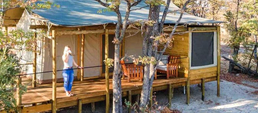 Mankwe Tented Retreat exterior with guest viewing the surrounding landscape