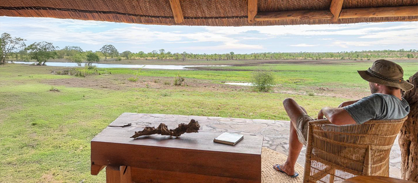 Man looks over the African grasslands in Zimbabwe